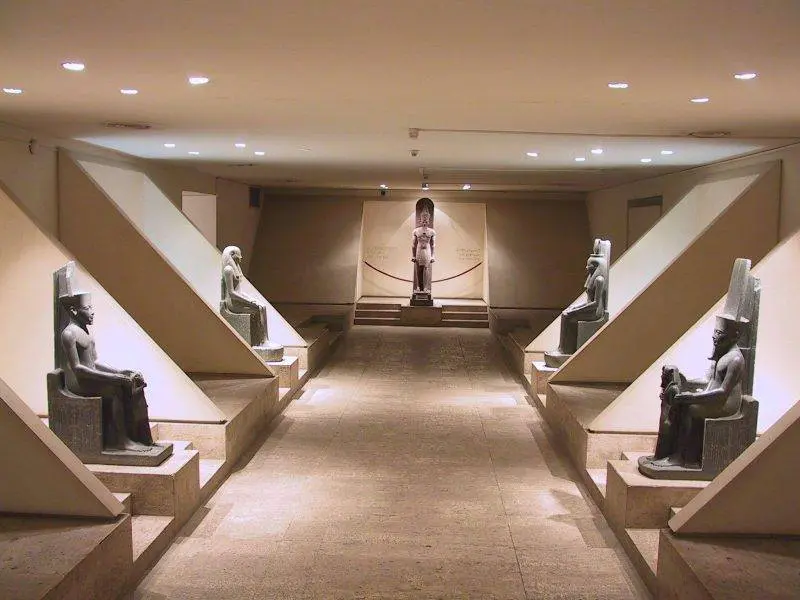 Tourists exploring Luxor Museum statues