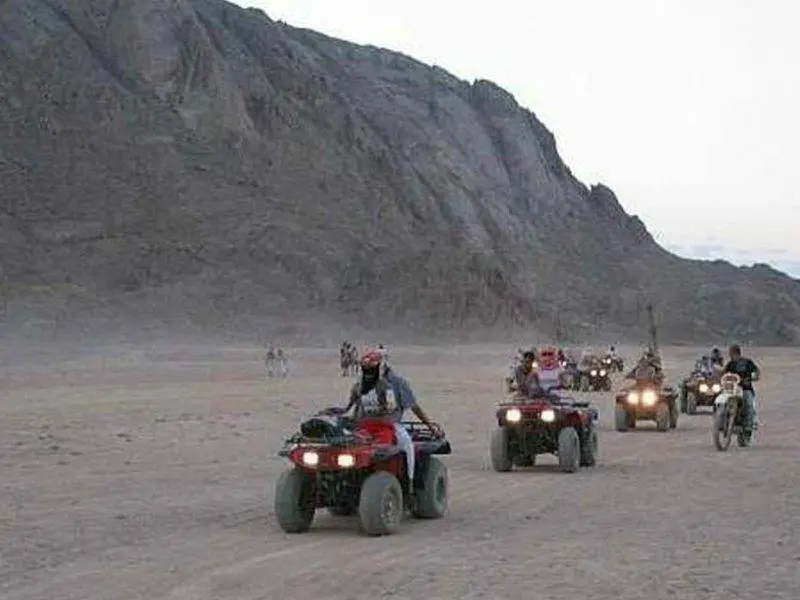 Adventurers exploring Hurghada desert on ATVs