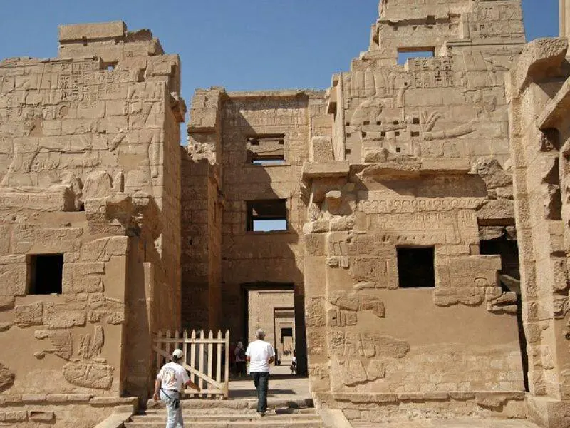 Guide explaining carvings at Habu Temple on West Bank tour