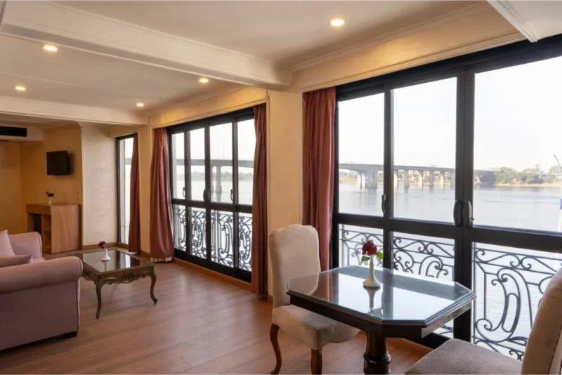 Modern lounge bar area on M/S Kleos Nile Cruise featuring comfortable seating, ambient lighting, and stunning Nile River scenery