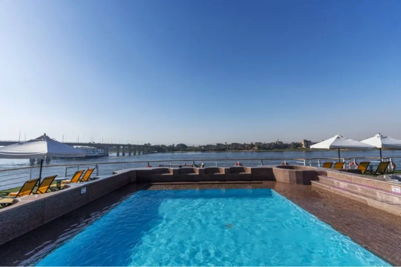Relaxing by the pool on the sundeck of the M/S Kleos Nile Cruise, perfect for sunset views and leisure on a luxury Nile cruise