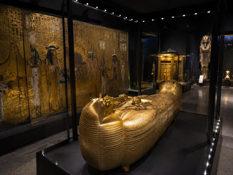 Golden coffin and treasures displayed inside the Tutankhamun Galleries at the Grand Egyptian Museum in Cairo Egypt