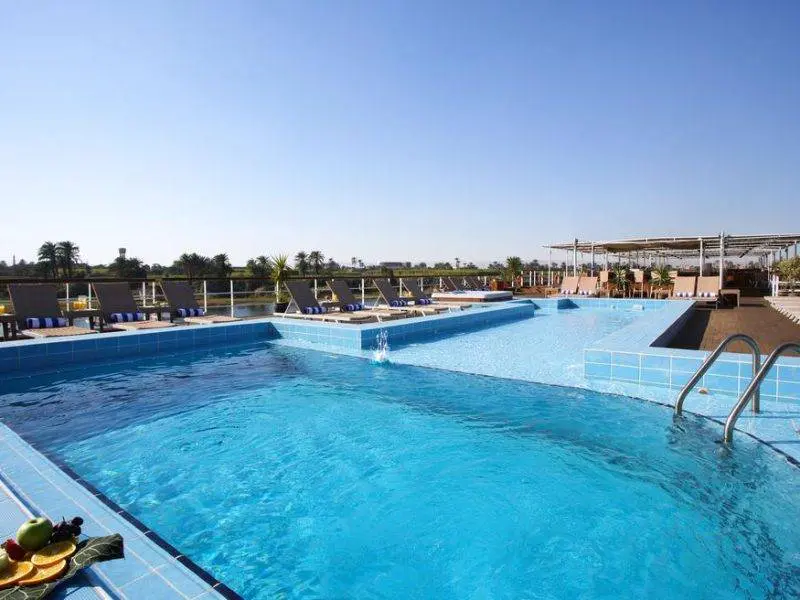 Relax by the pool on Mövenpick Royal Lotus Nile Cruise with Nile views