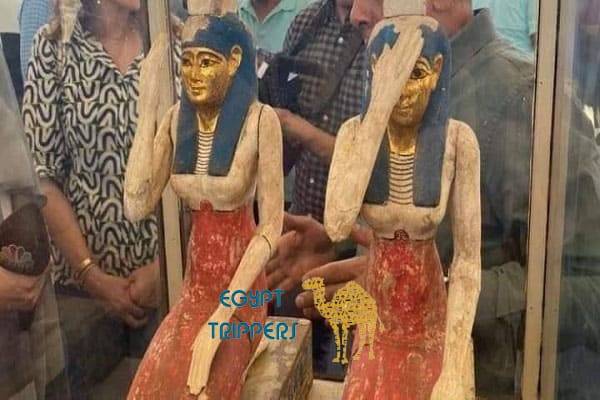 Two colorful wooden statues with a gilded face